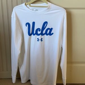 Long sleeve white Under Armour “heat gear” shirt that says UCLA on the front
